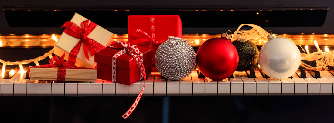 Piano keyboard with gifts and ornaments