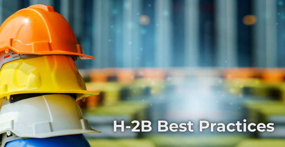 A stack of three construction hard hats—orange, yellow, and white—appears on the left side of the image. The background shows a blurred industrial setting with vertical lines and indistinct objects. Text on the right side of the image reads H‑2B Best Practices.